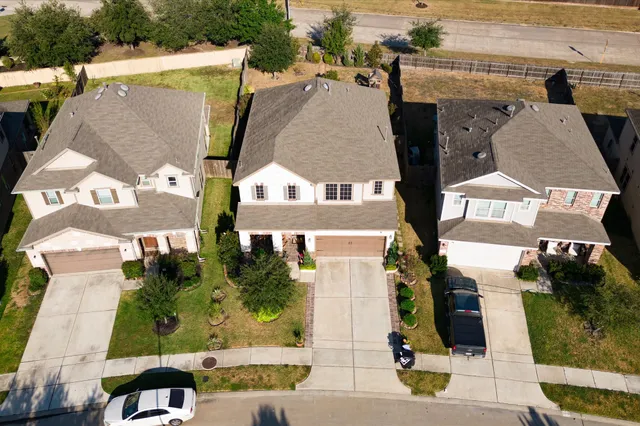 an aerial view of a house with garden space and wooden deck