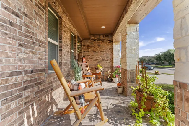 a view of balcony with two chairs and a table