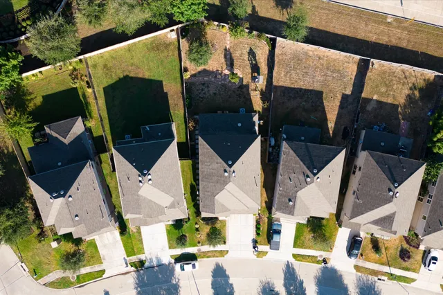 an aerial view of residential houses with outdoor space