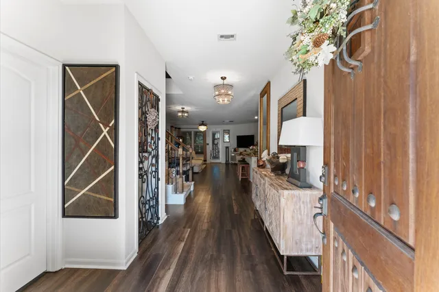 a view of a hallway with wooden floor and staircase