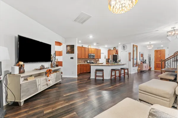 a living room with furniture a chandelier and a table