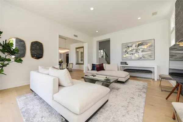 a large kitchen with kitchen island white cabinets and stainless steel appliances