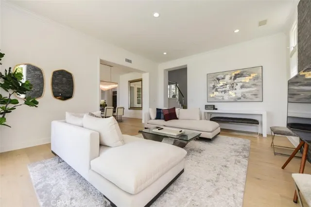 a large kitchen with kitchen island white cabinets and stainless steel appliances