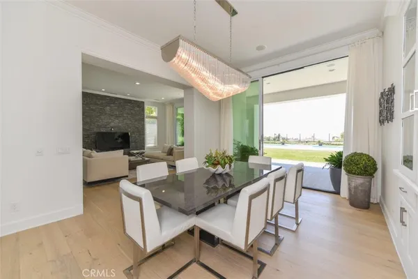 a kitchen with stainless steel appliances granite countertop a stove a sink a microwave a dining table and chairs