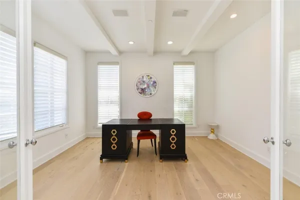 a living room with furniture potted plant floor to ceiling window and a fireplace