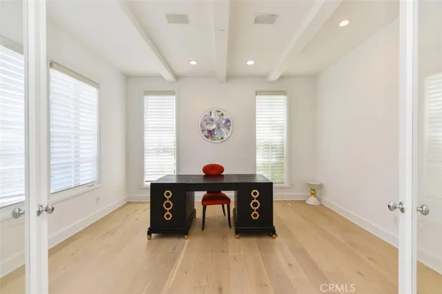 a living room with furniture potted plant floor to ceiling window and a fireplace
