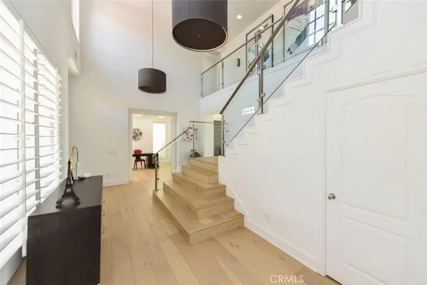 a dining room with furniture and a floor to ceiling window