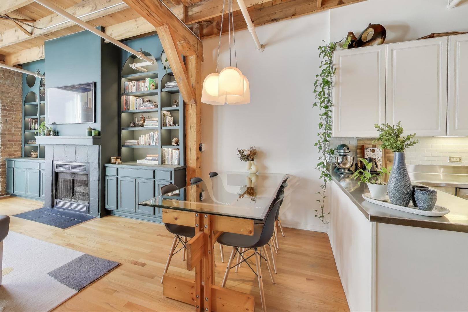 5235 North Ravenswood Avenue, Unit 3 Chicago, IL 60640 - Photo 12 of 27 a living room with furniture a chandelier and a dining table