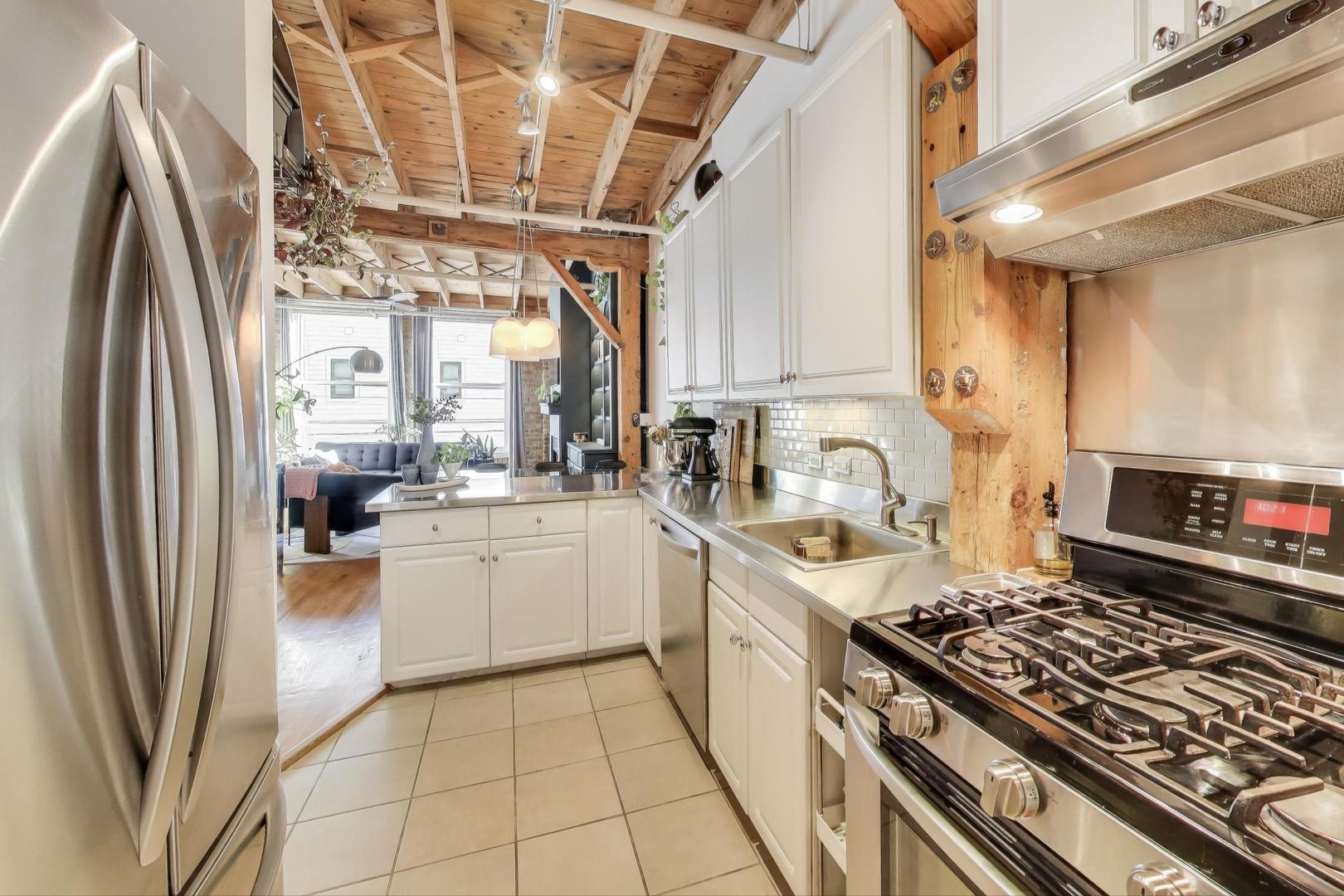 5235 North Ravenswood Avenue, Unit 3 Chicago, IL 60640 - Photo 15 of 27 a kitchen with stainless steel appliances granite countertop a stove a sink dishwasher and a refrigerator