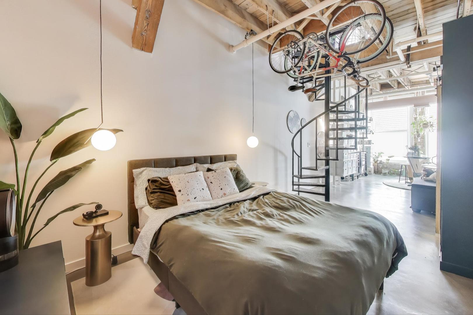 5235 North Ravenswood Avenue, Unit 3 Chicago, IL 60640 - Photo 16 of 27 a bedroom with a bed and a chandelier