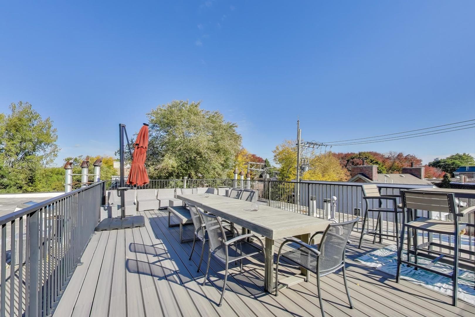 5235 North Ravenswood Avenue, Unit 3 Chicago, IL 60640 - Photo 22 of 27 a view of a chairs and table on the deck