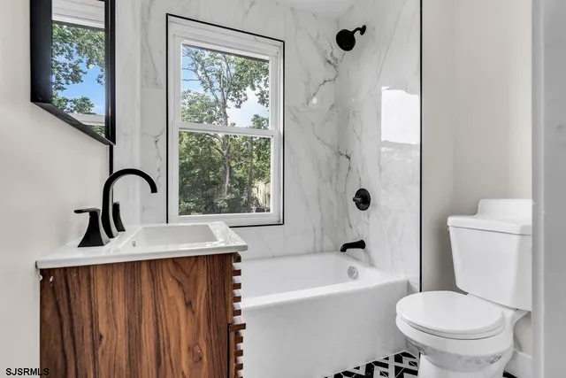 a bathroom with a sink toilet and a mirror
