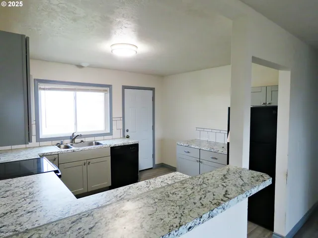 a large kitchen with kitchen island a sink stove and refrigerator