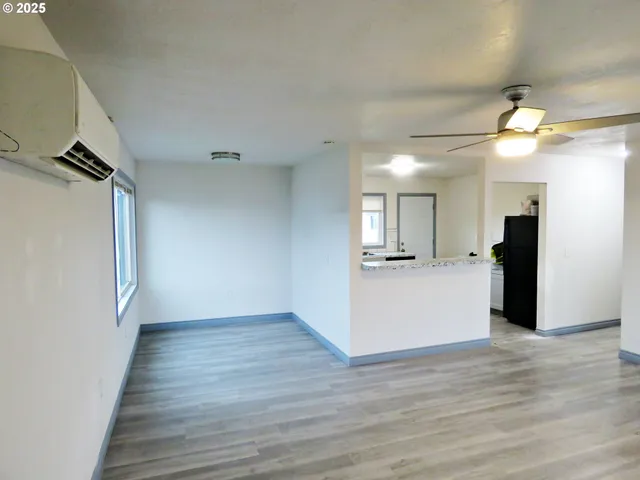 a view of a kitchen with a sink and a refrigerator