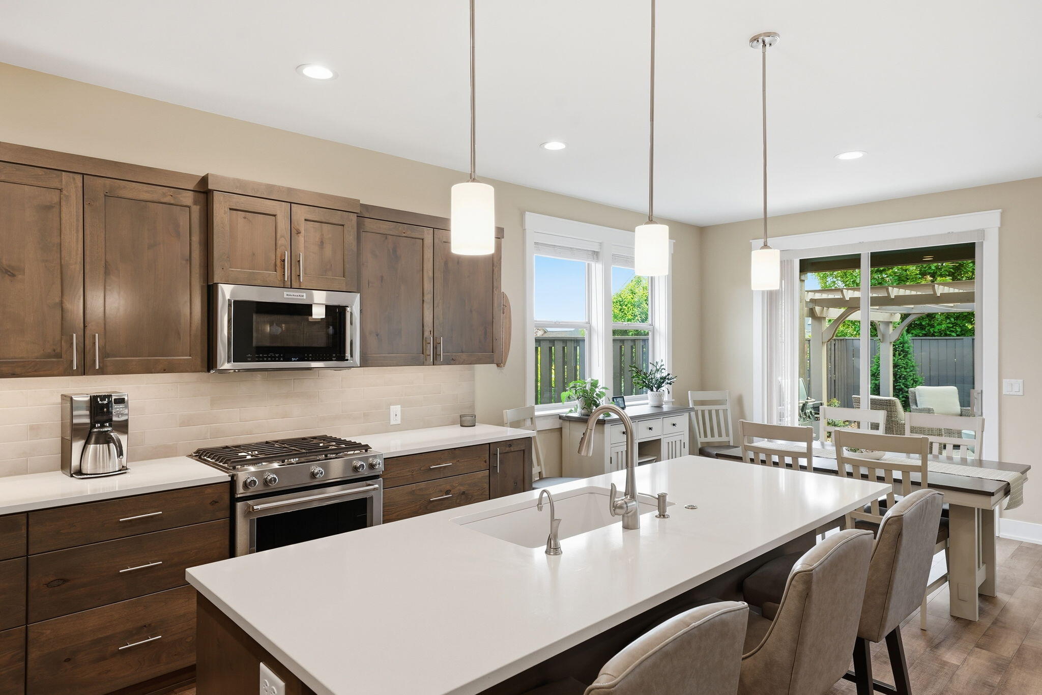 2714 Northwest 23rd Street Redmond, OR 97756 - Photo 12 of 57 a kitchen with stainless steel appliances granite countertop a sink a stove and a refrigerator