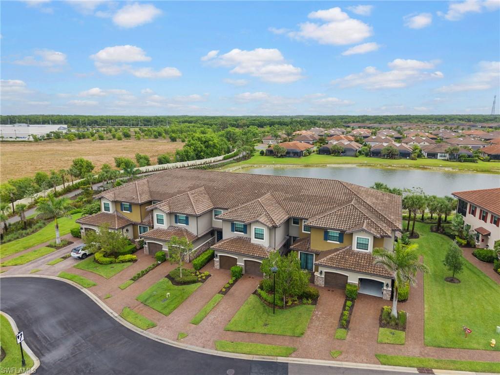 15244 Zeno Way, Unit 201 Naples, FL 34114 - Photo 2 of 48 an aerial view of residential houses with outdoor space and ocean view