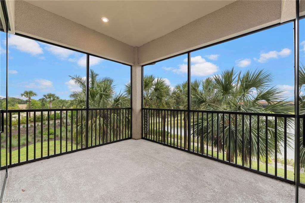 15244 Zeno Way, Unit 201 Naples, FL 34114 - Photo 27 of 48 a view of balcony with a floor to ceiling window and wooden fence