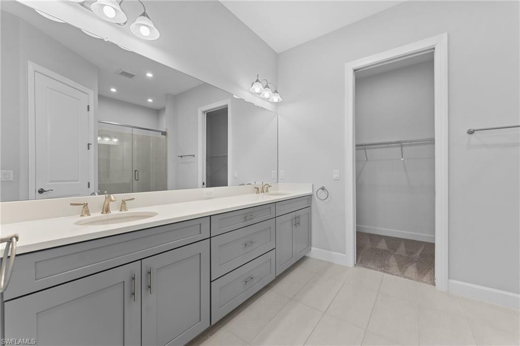 15244 Zeno Way, Unit 201 Naples, FL 34114 - Photo 35 of 48 a bathroom with a double vanity sink mirror and double