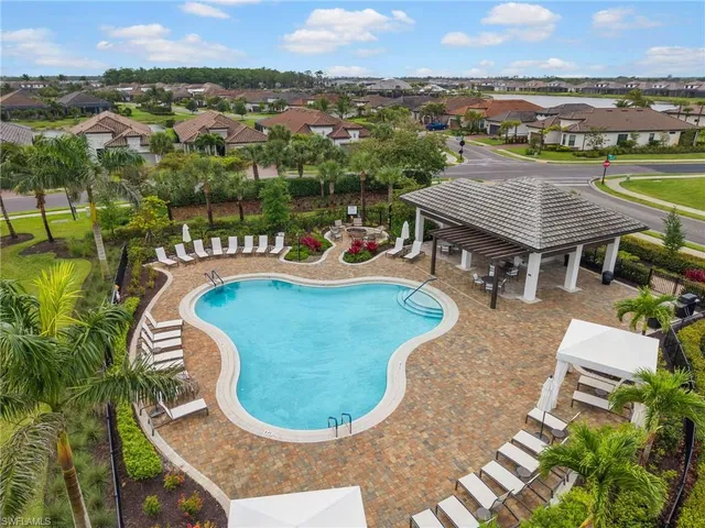 an aerial view of a house with a swimming pool and lake view