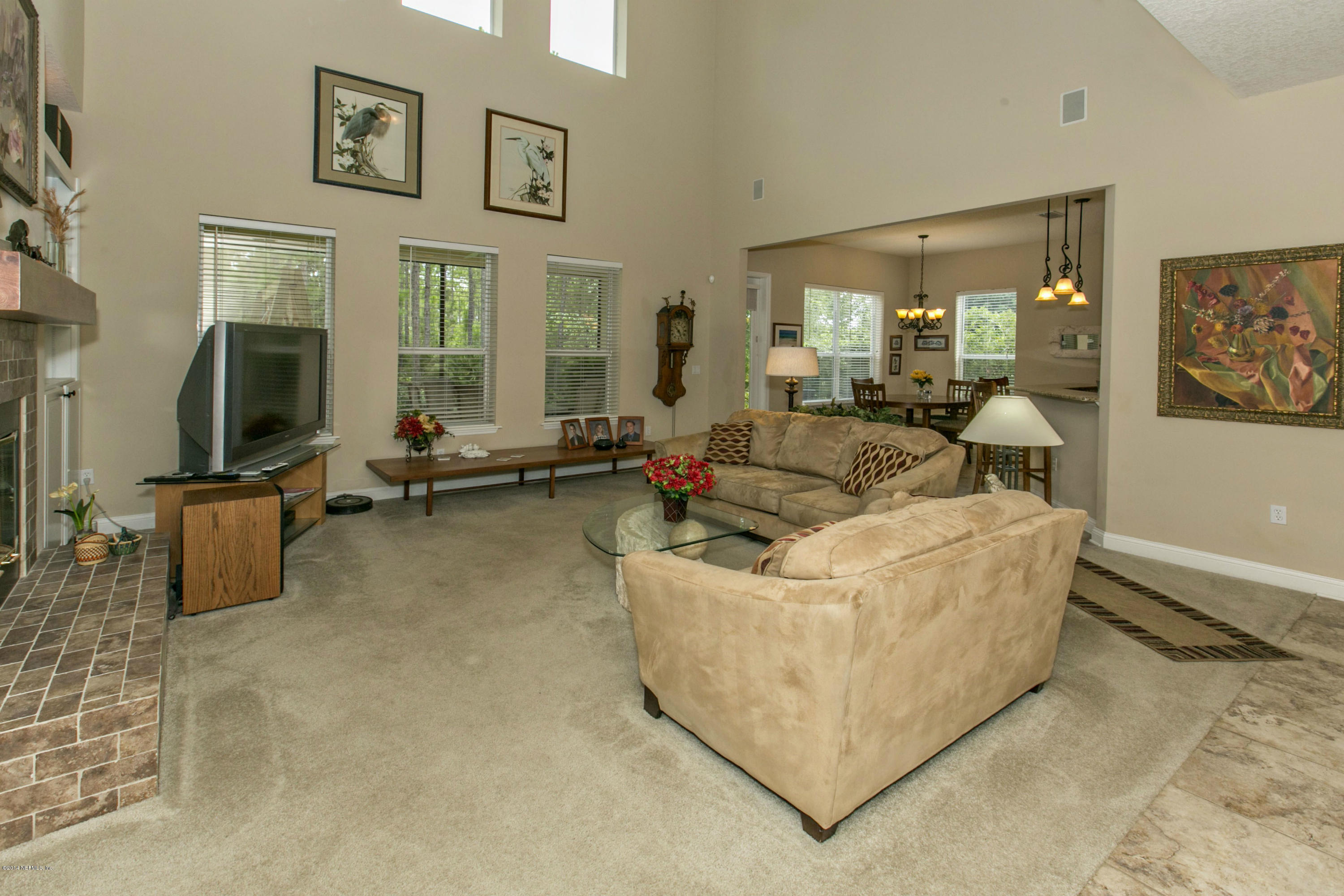 1326 Powis Road St. Augustine, FL 32095 - Photo 11 of 26 a living room with furniture gym equipment and a flat screen tv