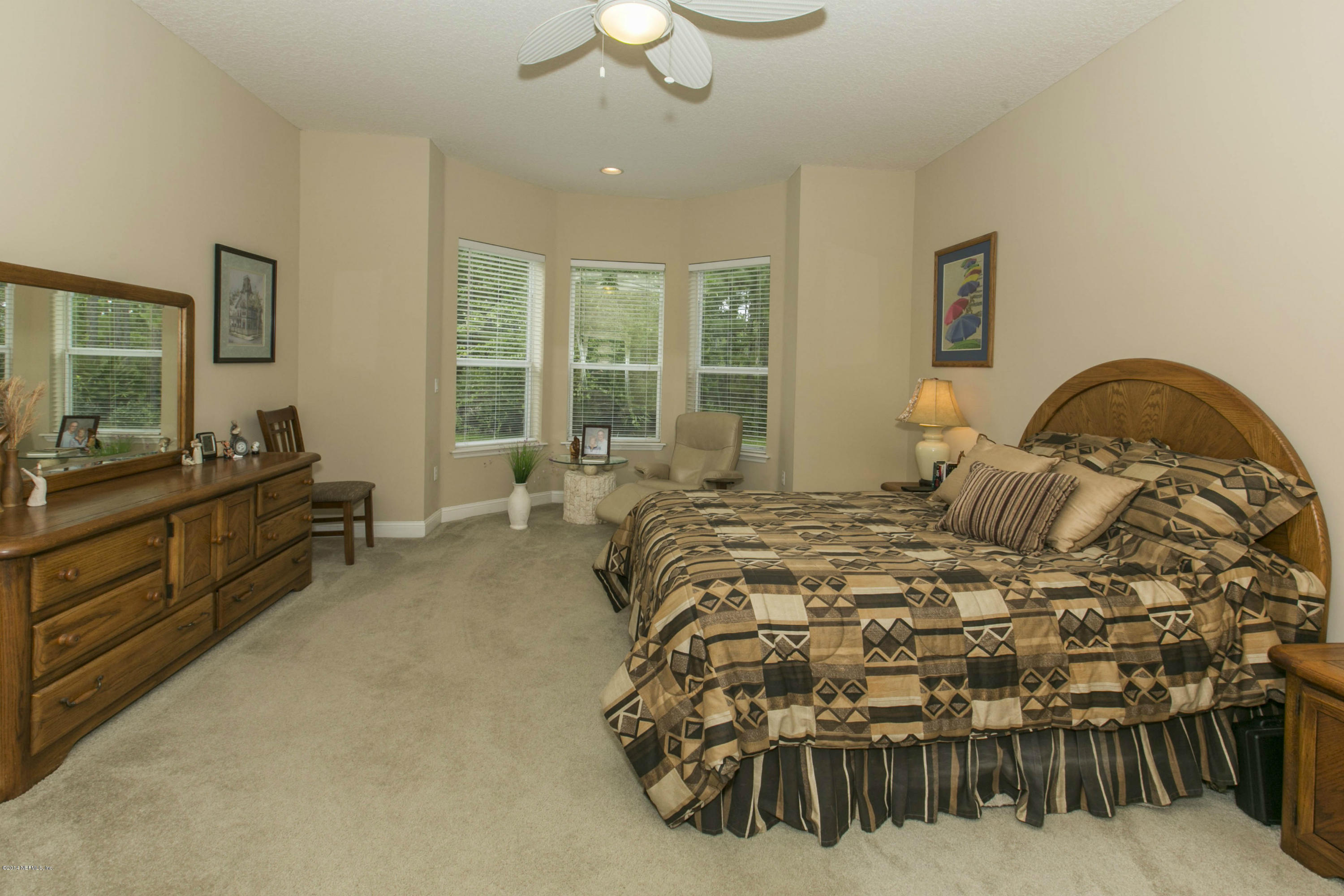 1326 Powis Road St. Augustine, FL 32095 - Photo 13 of 26 a bedroom with a bed a couch and dresser