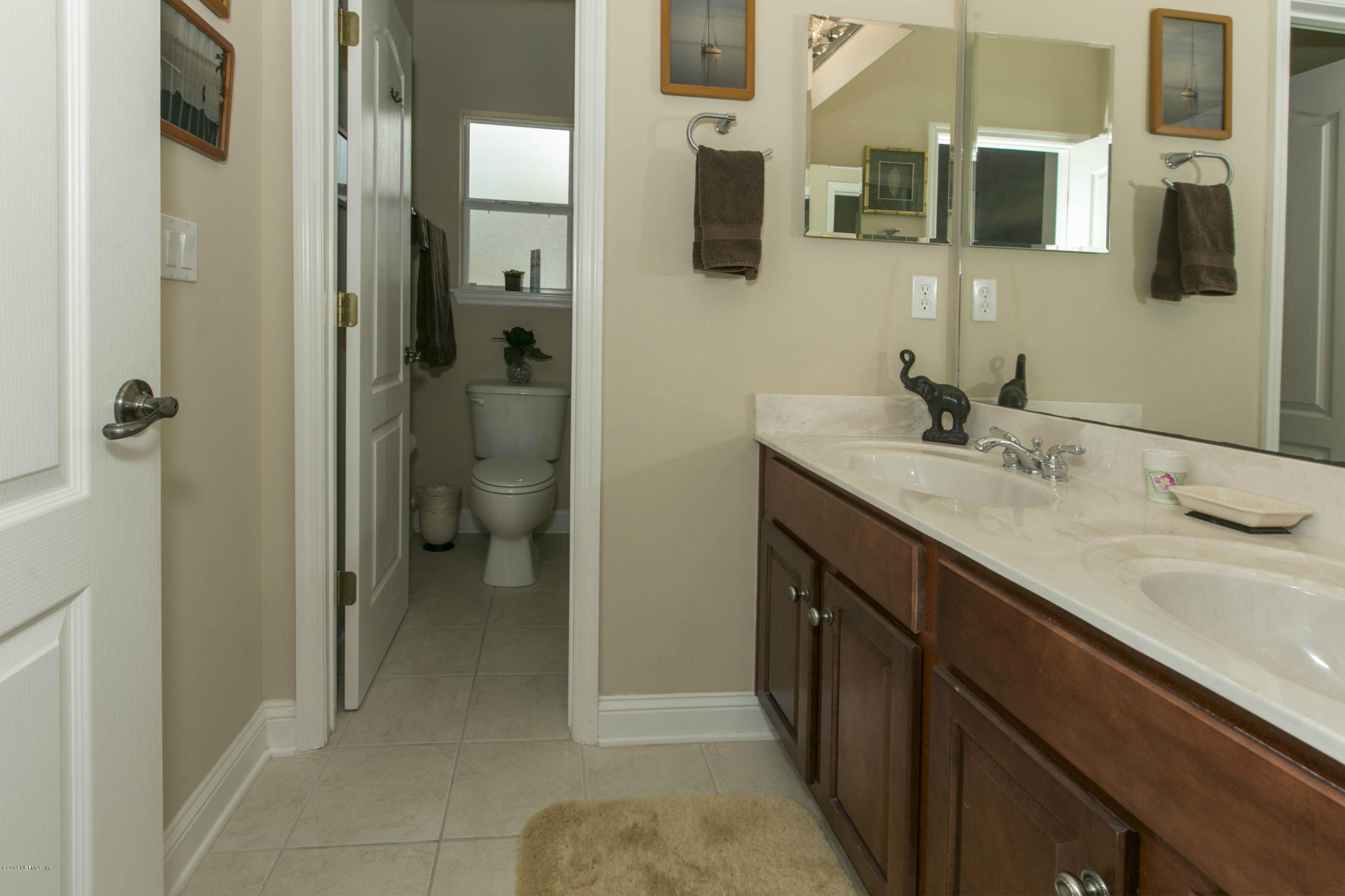 1326 Powis Road St. Augustine, FL 32095 - Photo 19 of 26 a bathroom with a granite countertop sink a toilet and shower