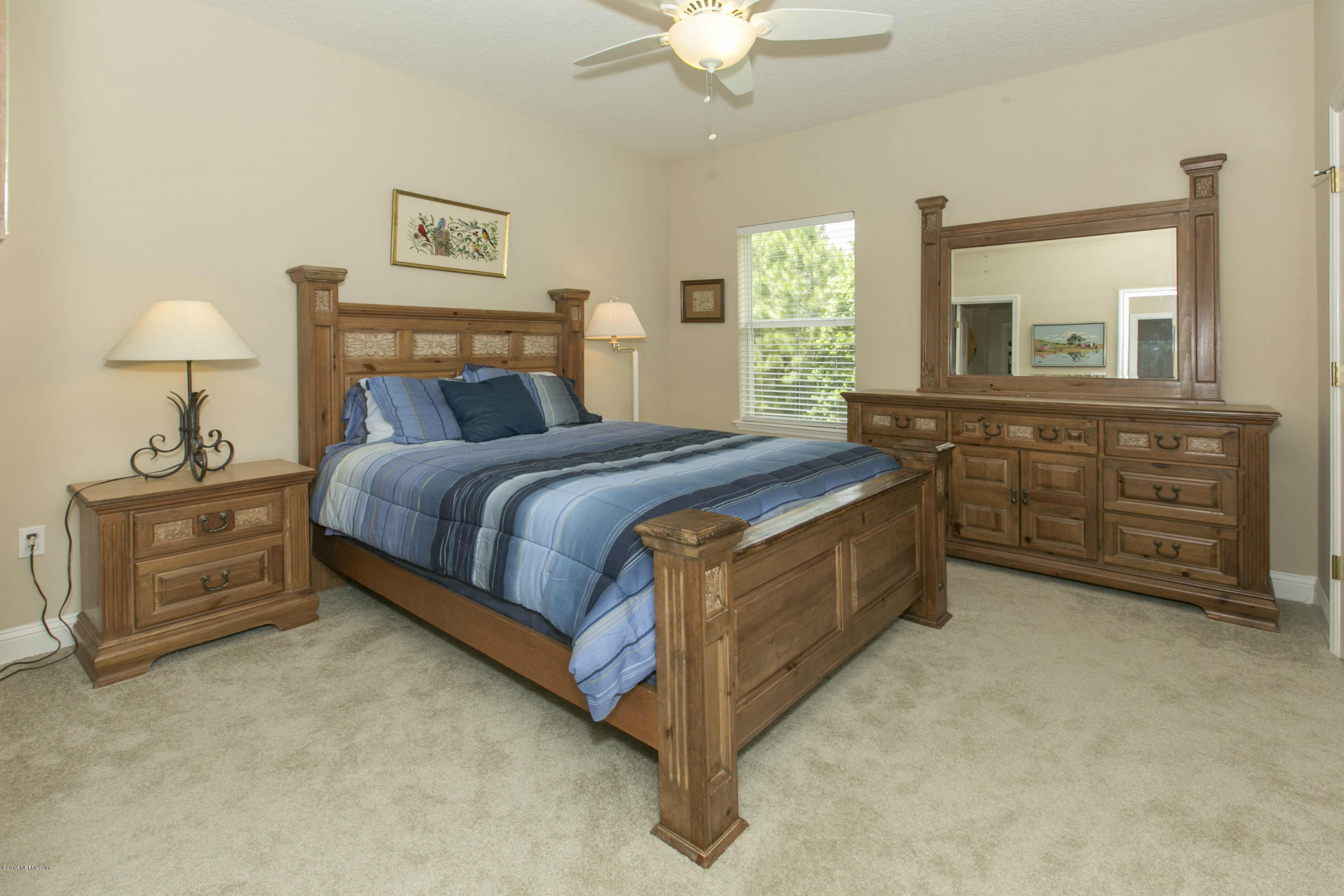 1326 Powis Road St. Augustine, FL 32095 - Photo 21 of 26 a bedroom with a bed and a dresser