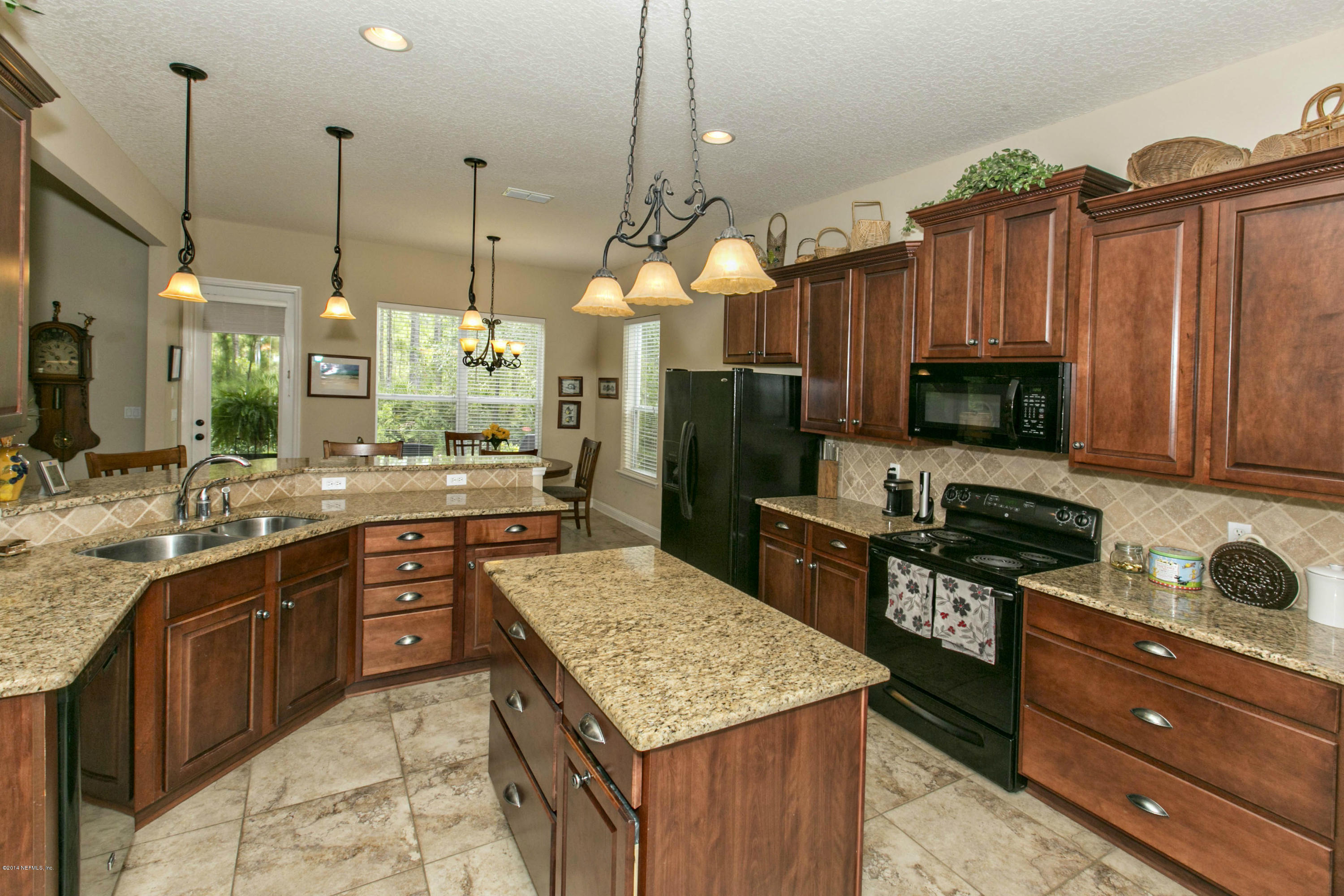 1326 Powis Road St. Augustine, FL 32095 - Photo 8 of 26 a kitchen with granite countertop a sink dishwasher stove and oven with wooden floor