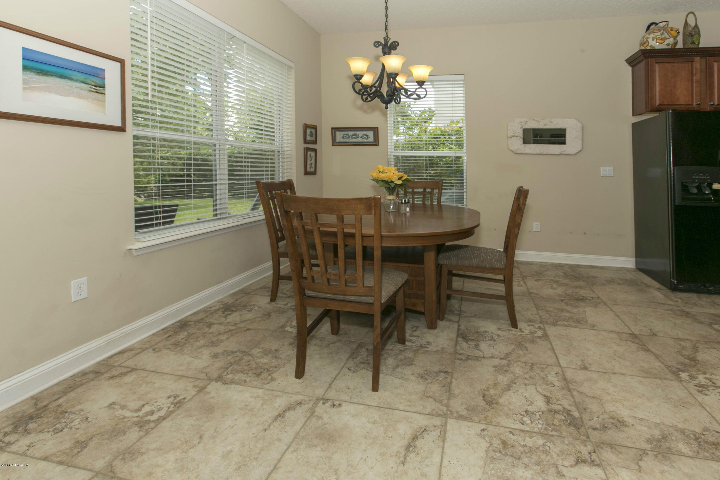 1326 Powis Road St. Augustine, FL 32095 - Photo 9 of 26 a view of a dining room with furniture and a chandelier