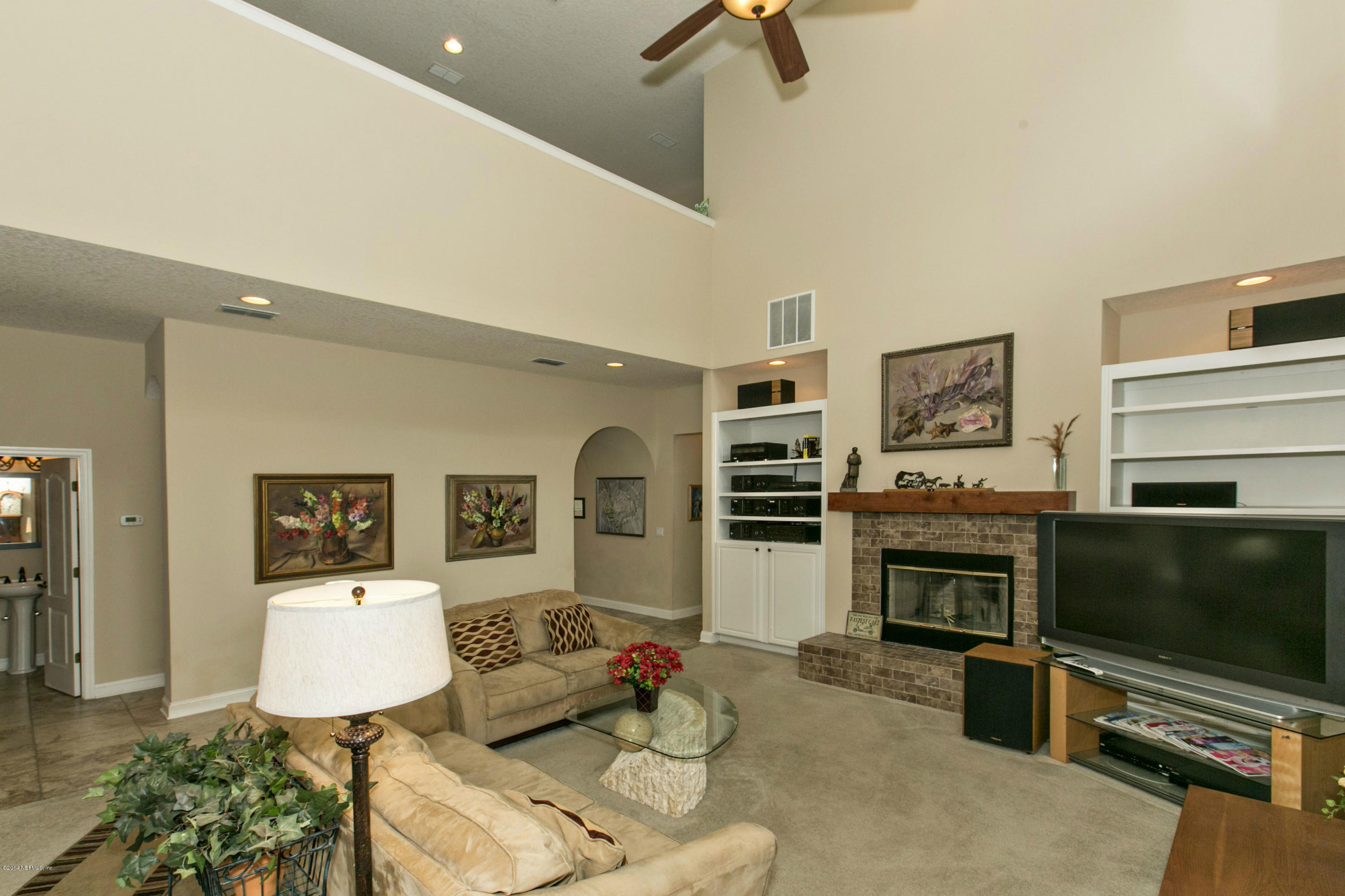 1326 Powis Road St. Augustine, FL 32095 - Photo 10 of 26 a living room with furniture flat screen tv and a fireplace
