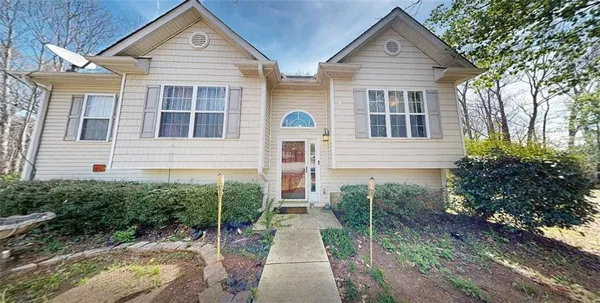 a view of a brick house with large windows