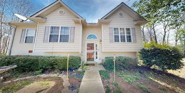 a view of a brick house with large windows