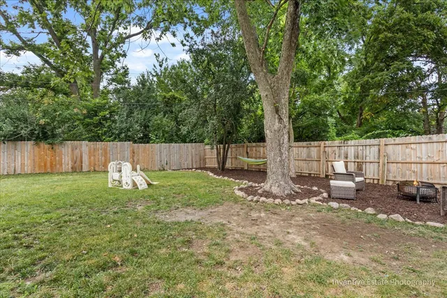 a swimming pool with outdoor seating and yard