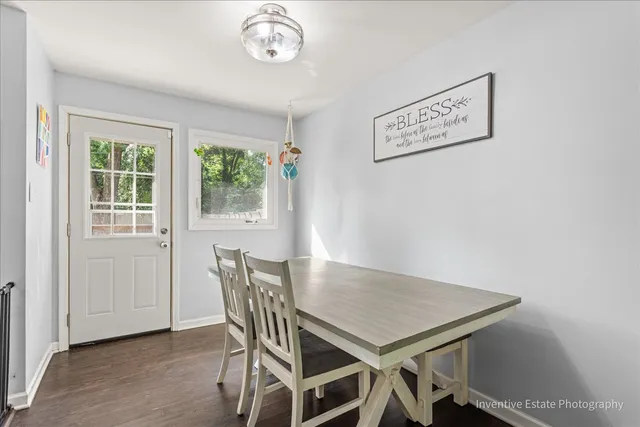 a view of a dining room with furniture and a window