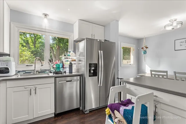 a kitchen with stainless steel appliances granite countertop a refrigerator and a sink