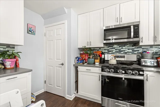 a kitchen with stainless steel appliances a stove a microwave and cabinets