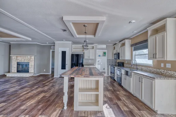 a kitchen with granite countertop a sink and a stove top oven
