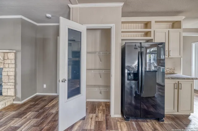 a view of an empty room with a fireplace and a window