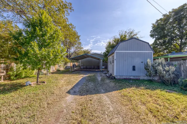 a view of a barn in the middle of a yard
