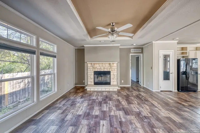 a room with stainless steel appliances kitchen island granite countertop a refrigerator and stove top oven