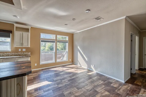 a large kitchen with granite countertop a large counter top space a sink stainless steel appliances and cabinets