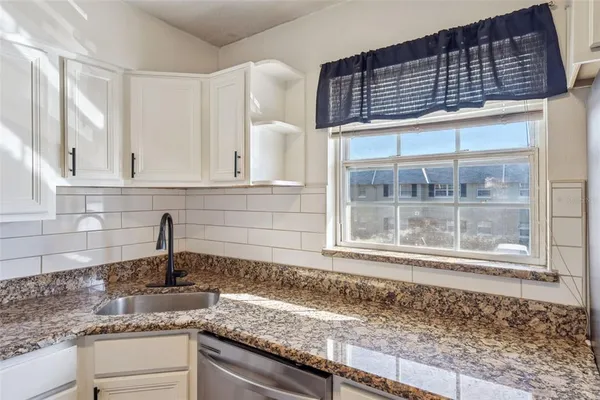 a kitchen with a sink and cabinets