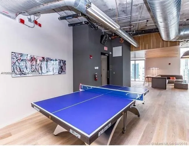 a room with pool table and windows