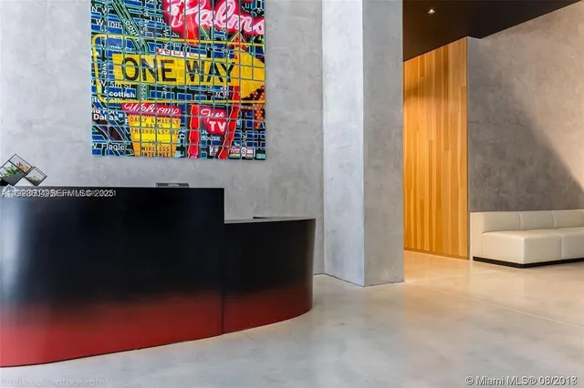 a living room with furniture and a floor to ceiling window