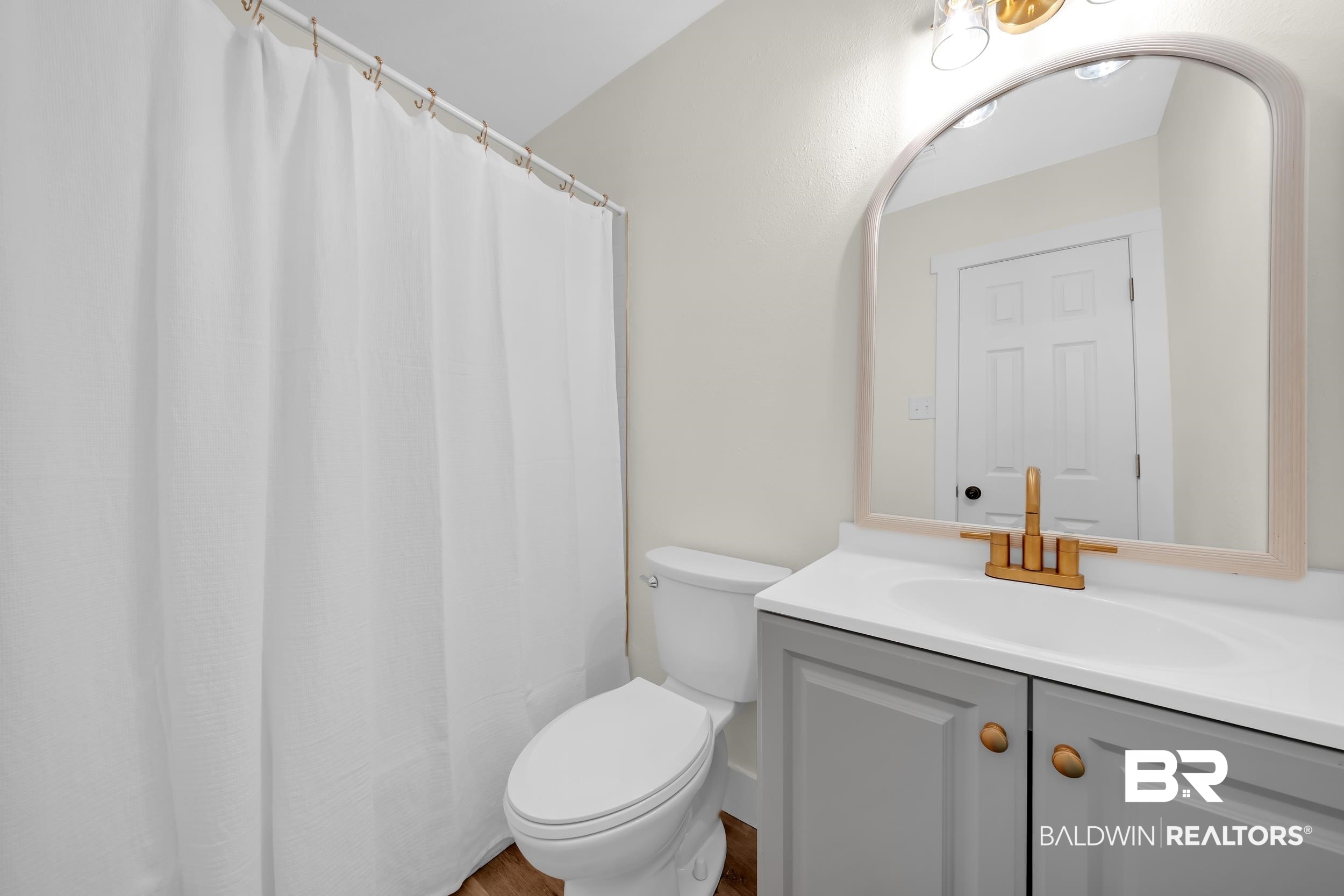 5109 McDonald Road Theodore, AL 36582 - Photo 16 of 21 Bathroom with a gray vanity, white countertop, and gold-finish faucet