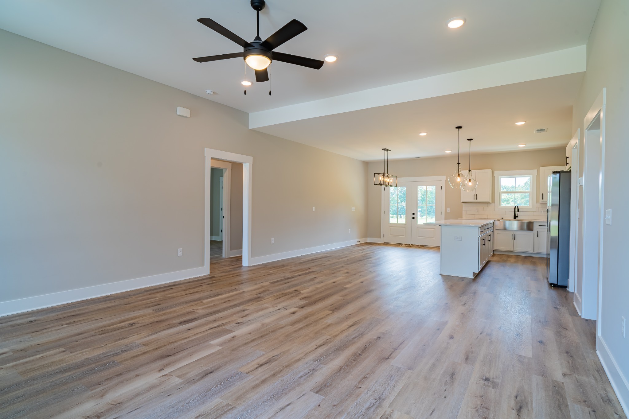 189 Strawberry Ridge Manchester, TN 37355 - Photo 15 of 56 a view of an empty room and kitchen with wooden floor