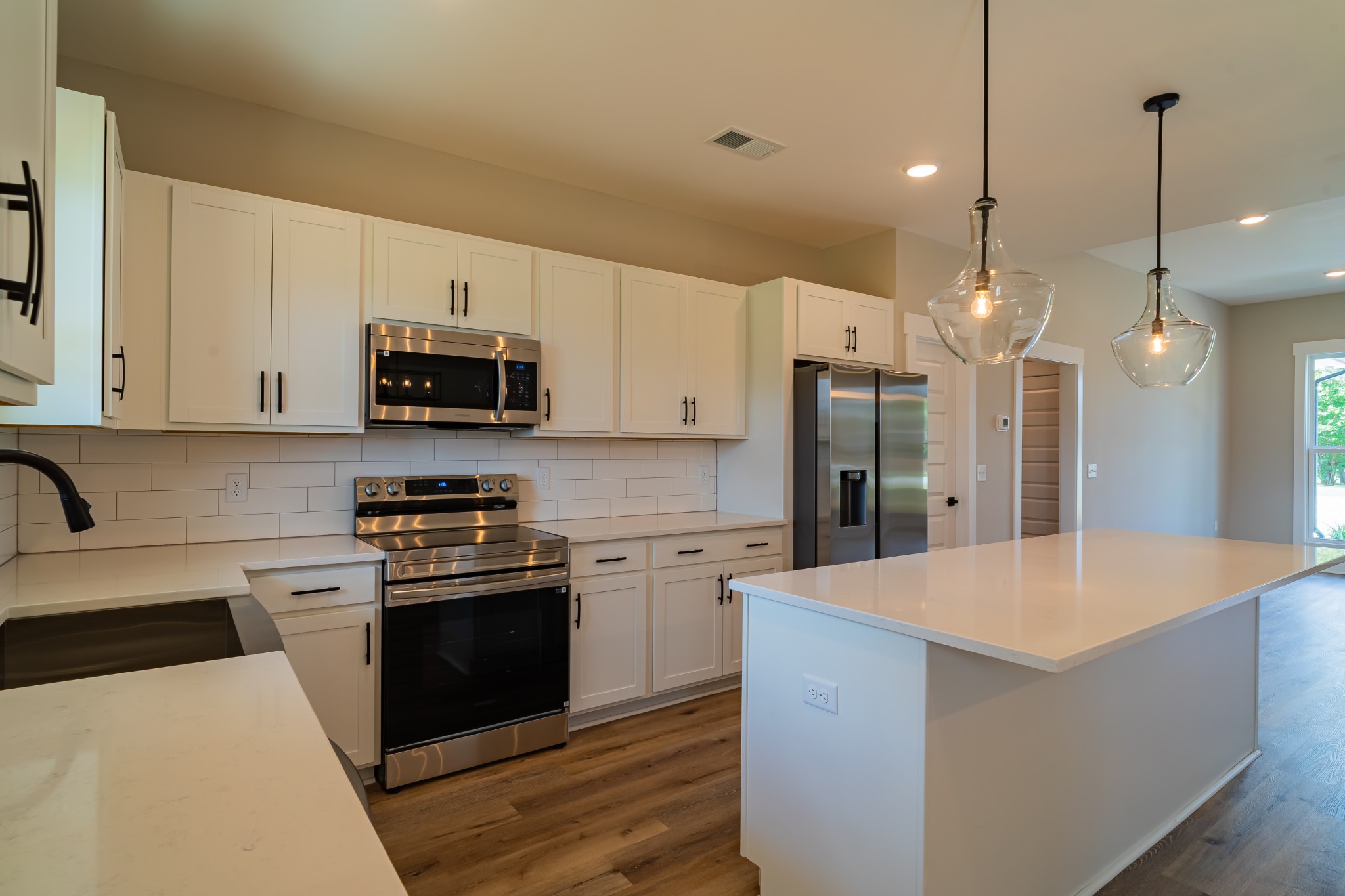 189 Strawberry Ridge Manchester, TN 37355 - Photo 19 of 56 a kitchen with a sink a stove a refrigerator and cabinets