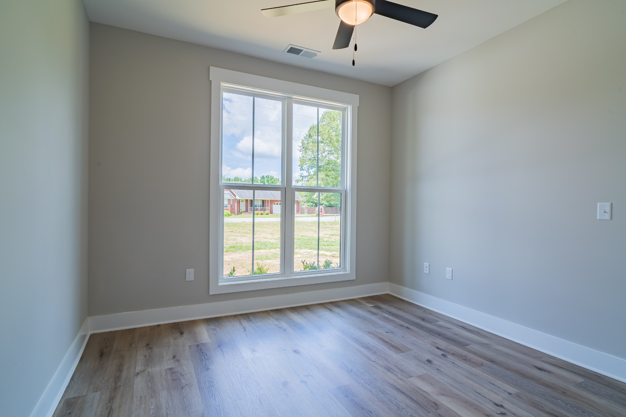 189 Strawberry Ridge Manchester, TN 37355 - Photo 44 of 56 an empty room with wooden floor fan and windows