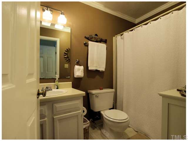 5635 Bridgetowne Way Raleigh, NC 27609 - Photo 11 of 18 a bathroom with a sink toilet mirror and shower