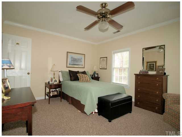 5635 Bridgetowne Way Raleigh, NC 27609 - Photo 12 of 18 a bedroom with a bed and a dresser